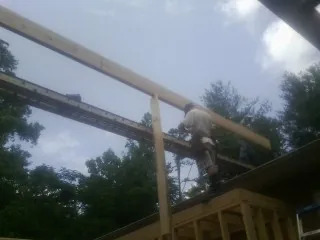Carpenter setting a ridge beam over a new addition frame — Ice Dam Removal by Roofing Brothers in Upper Sandusky