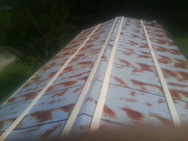 Rusted metal roof panels with new wood purlins before replacement — Storm Damage Roof Repair in Upper Sandusky by Roofing Brothers